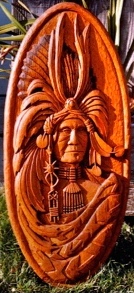 Carved portrait plaque of a chief in a headdress