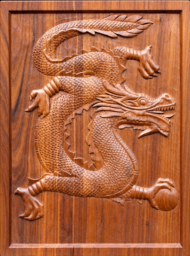 Hand-carved dragon relief panel in walnut